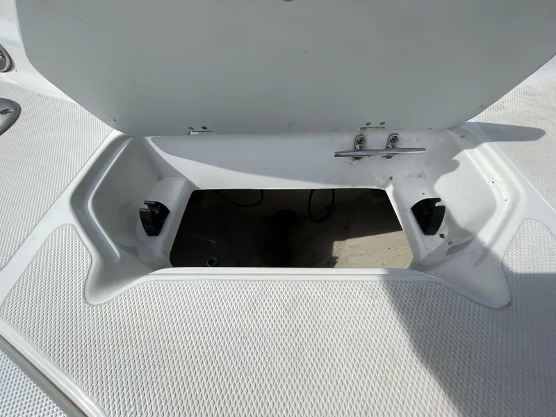 Slide: The Image of An open storage compartment on a 2018 Hurricane SS202 boat, featuring a white interior. - 13