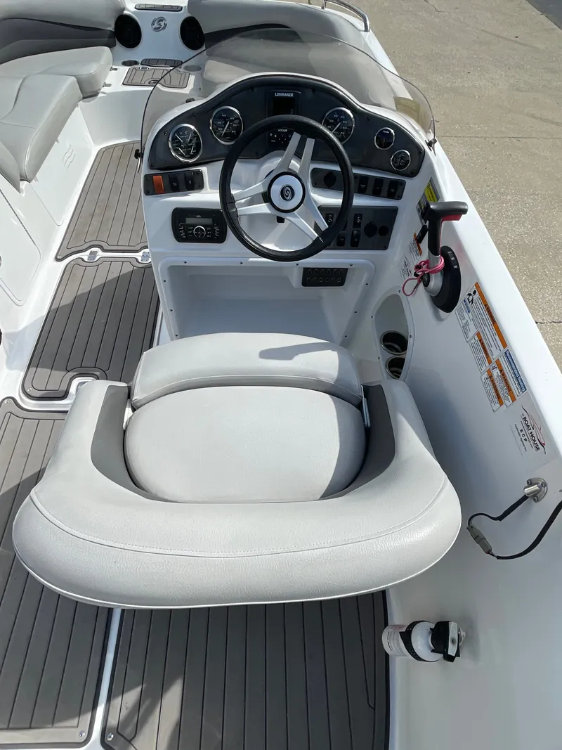 Slide: The Image of The image shows the cockpit of a 2018 Hurricane SS202 boat with a gray steering wheel and instruments. - 19