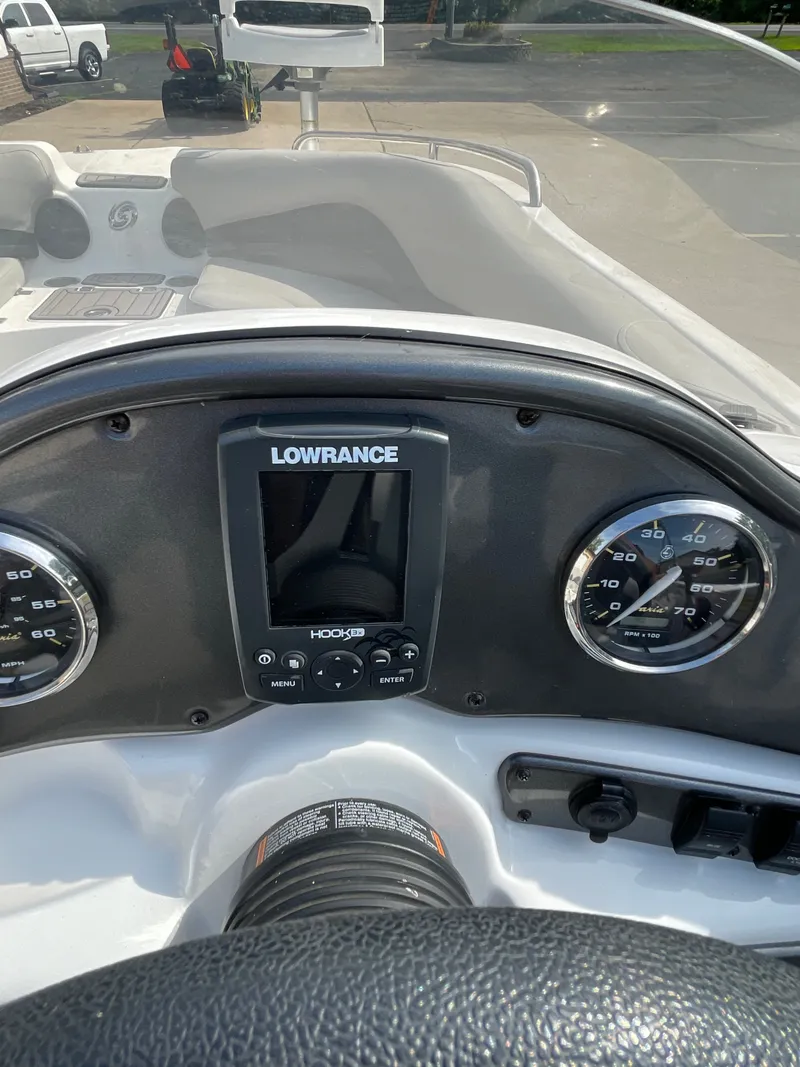 Slide: The Image of The dashboard of a 2018 Hurricane SS202 boat featuring a Lowrance GPS system. - 24