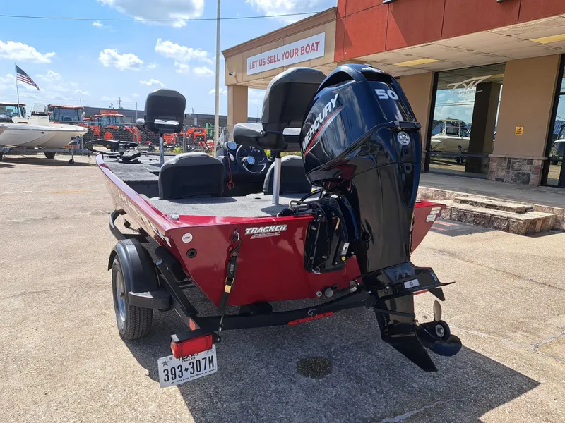 Slide: The Image of A red 2022 Tracker Pro 170 boat on a trailer in front of a building. - 12