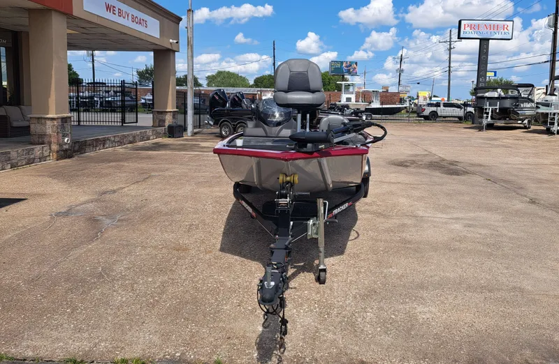 Slide: The Image of A 2022 Tracker Pro 170 boat on a trailer in front of a store. The sky is clear. - 3