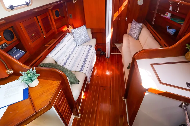 Slide: The Image of Interior of 1988 Tartan 34-2 sailboat with cozy seating and wooden finishes. - 26