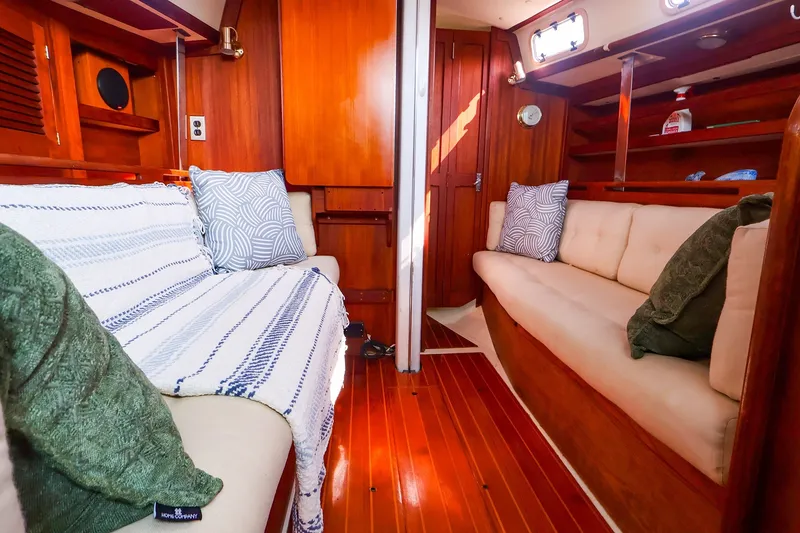 Slide: The Image of Cozy interior of 1988 Tartan 34-2 sailboat with wooden finishes and cushioned seating. - 28