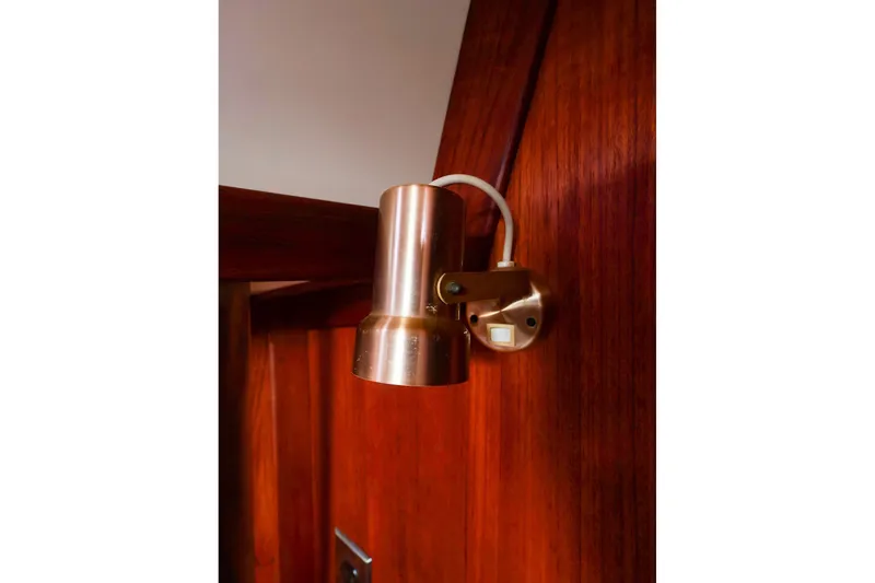 Slide: The Image of Brass wall light fixture on 1988 Tartan 34-2 yacht interior with wooden paneling. - 45