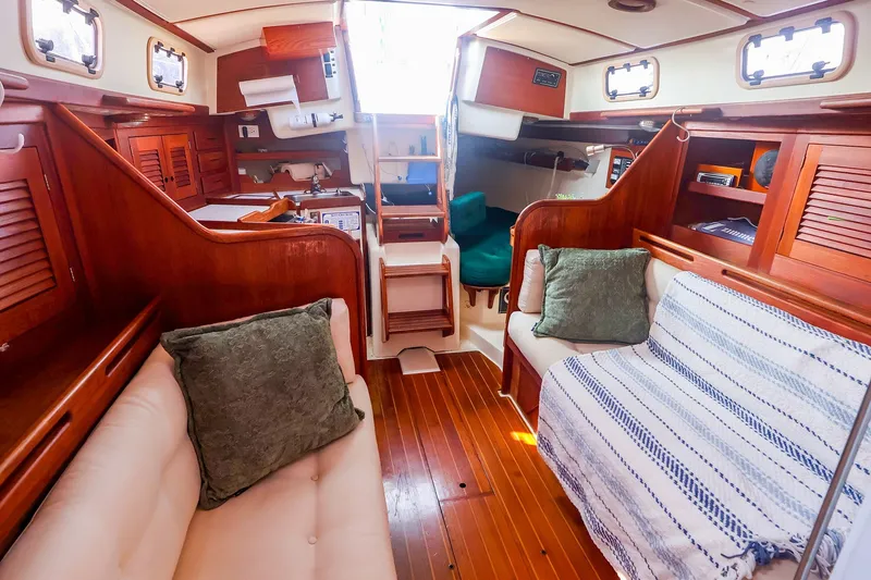 Slide: The Image of Interior of a 1988 Tartan 34-2 sailboat with cozy seating and wooden finishes. - 31