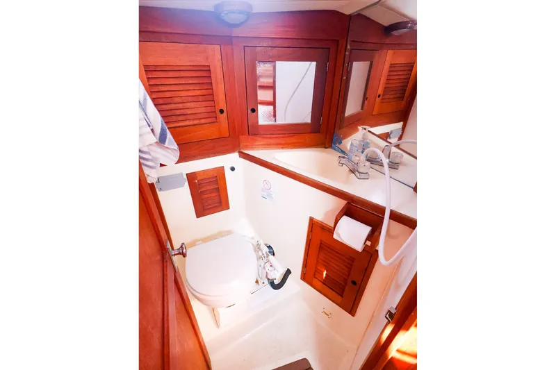 Slide: The Image of 1988 Tartan 34-2 yacht bathroom with wooden cabinets and compact fixtures. - 42