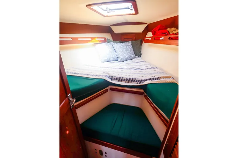 Slide: The Image of Cozy cabin interior of 1988 Tartan 34-2 sailboat with comfortable bedding and natural light. - 38