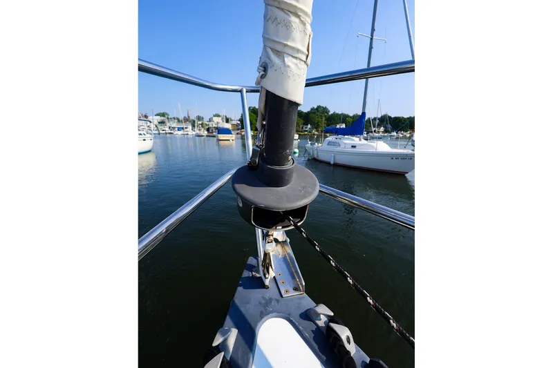 Slide: The Image of Bow view of a 1988 Tartan 34-2 sailboat docked in a marina. - 24