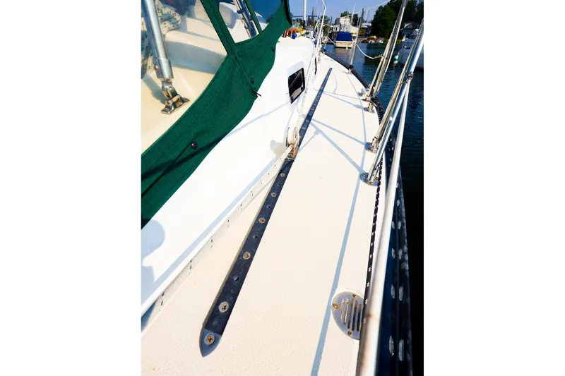 Slide: The Image of 1988 Tartan 34-2 sailboat deck with green canvas, docked in marina. - 21