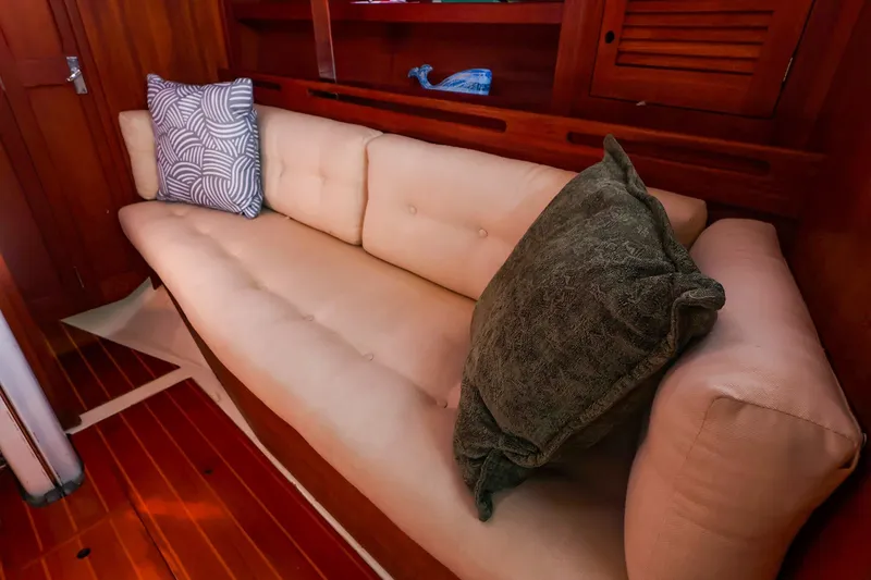 Slide: The Image of 1988 Tartan 34-2 yacht interior with beige sofa and decorative pillows. - 30
