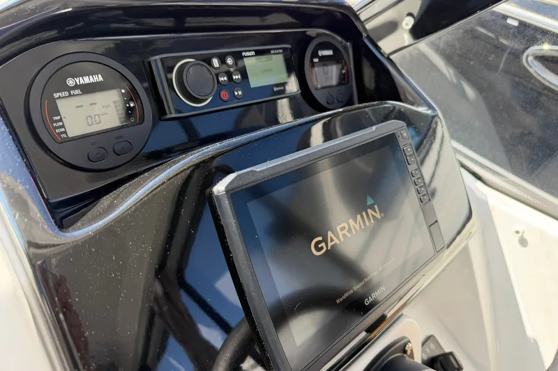 Slide: The Image of Dashboard of a 2019 Jeanneau NC 695 boat with Garmin and Yamaha displays. - 24
