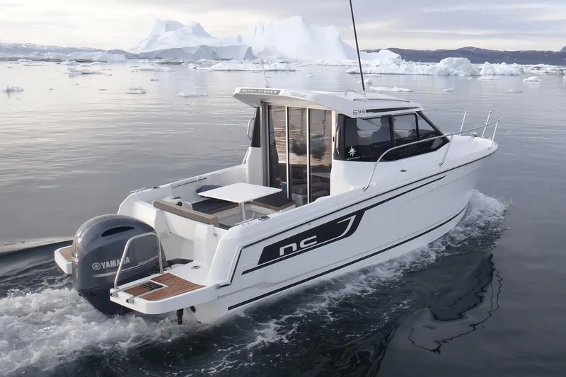 Slide: The Image of Manufacturer Provided Image: 2019 Jeanneau NC 695 boat cruising in icy waters with icebergs in the background. - 1