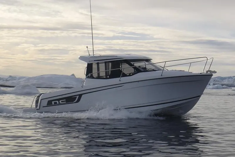 Slide: The Image of Manufacturer Provided Image: 2019 Jeanneau NC 695 boat cruising on calm waters with an icy backdrop. - 2
