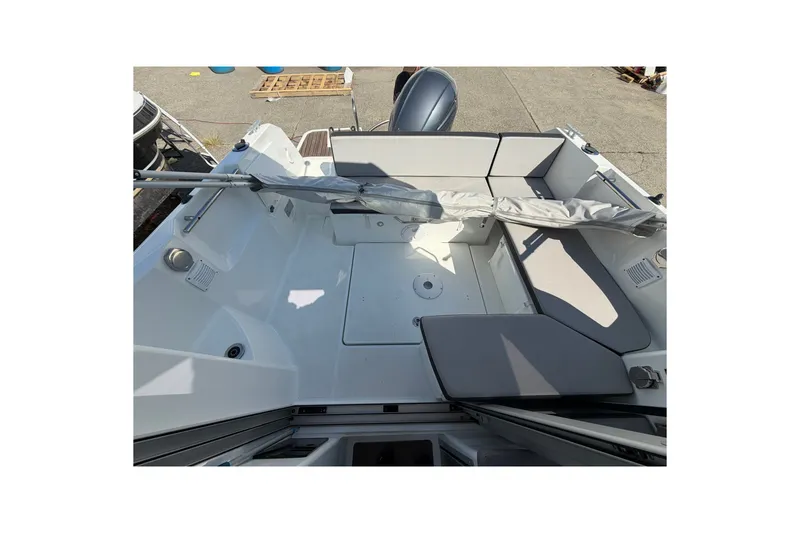 Slide: The Image of 2019 Jeanneau NC 695 boat interior with seating and storage area. - 17