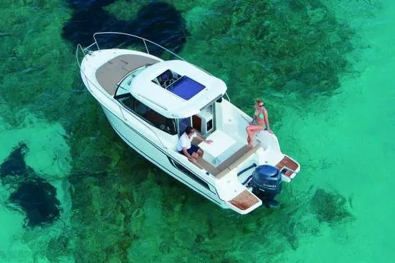 Slide: The Image of Manufacturer Provided Image: 2019 Jeanneau NC 695 boat cruising on clear turquoise water. - 3