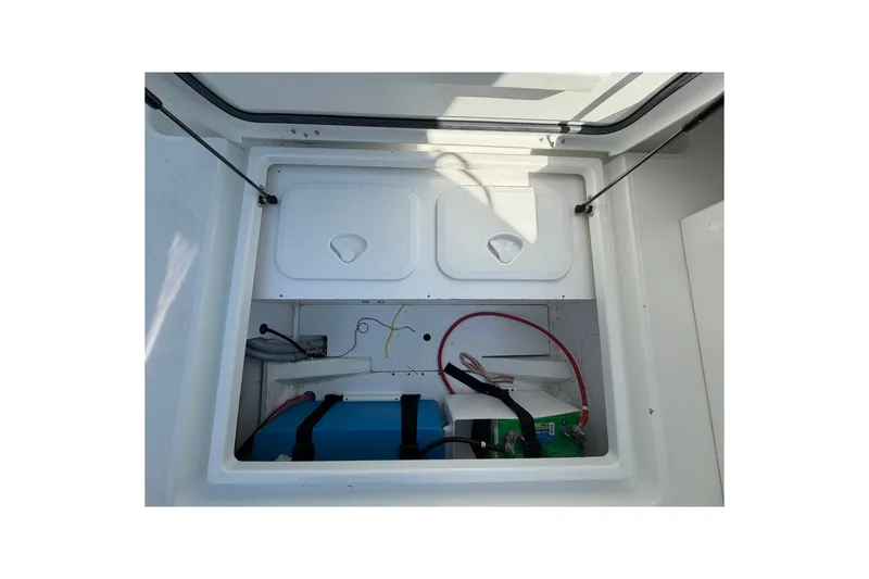 Slide: The Image of Storage compartment of a 2019 Jeanneau NC 695 boat, featuring organized equipment. - 18