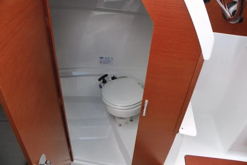 Slide: The Image of Manufacturer Provided Image: 2019 Jeanneau NC 695 boat interior bathroom with wooden door. - 9