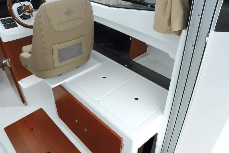 Slide: The Image of Manufacturer Provided Image: 2019 Jeanneau NC 695 boat interior with helm seat and storage compartments. - 6