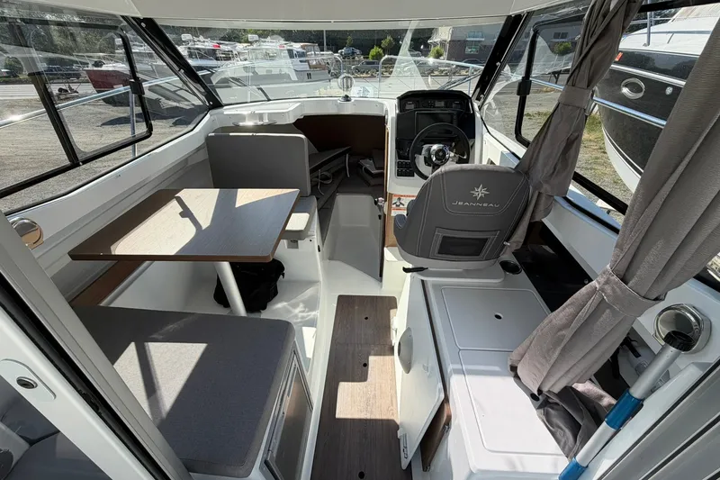 Slide: The Image of Interior of 2019 Jeanneau NC 695 boat with seating, table, and helm station. - 19