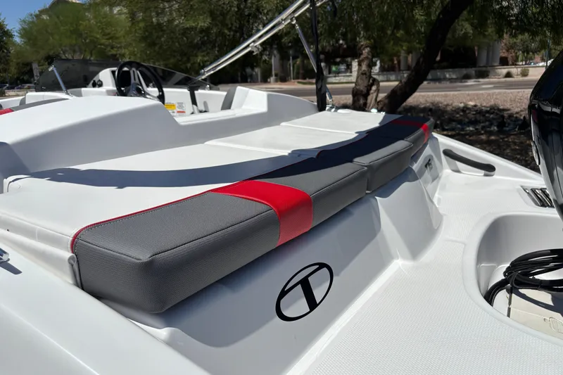 Slide: The Image of 2027 Tahoe T16 boat with sleek seating and modern design in a sunny outdoor setting. - 19