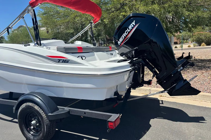 Slide: The Image of 2027 Tahoe T16 boat with Mercury outboard motor on a trailer. - 2