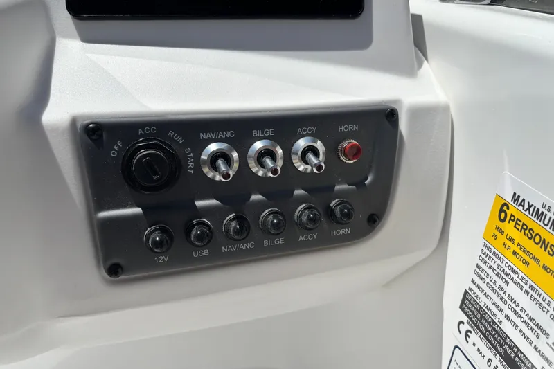 Slide: The Image of Control panel of a 2027 Tahoe T16 boat with switches and capacity label. - 7