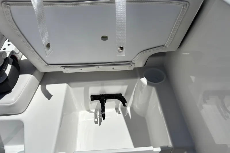 Slide: The Image of Interior view of 2027 Tahoe T16 boat storage compartment with cup holder and strap. - 18