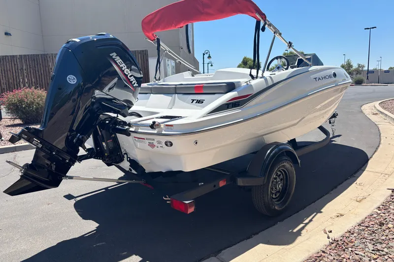 Slide: The Image of 2027 Tahoe T16 boat with Mercury engine on trailer, parked outdoors. - 4