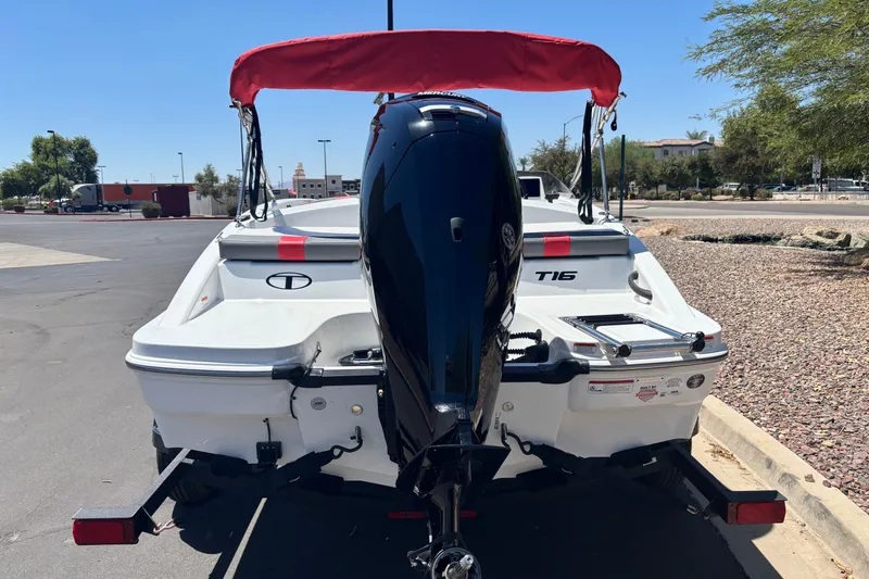 Slide: The Image of 2027 Tahoe T16 boat with red canopy and outboard motor in parking lot. - 3