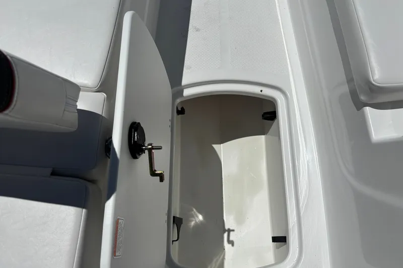 Slide: The Image of Open storage compartment on a 2027 Tahoe T16 boat, showcasing interior space and latch mechanism. - 14