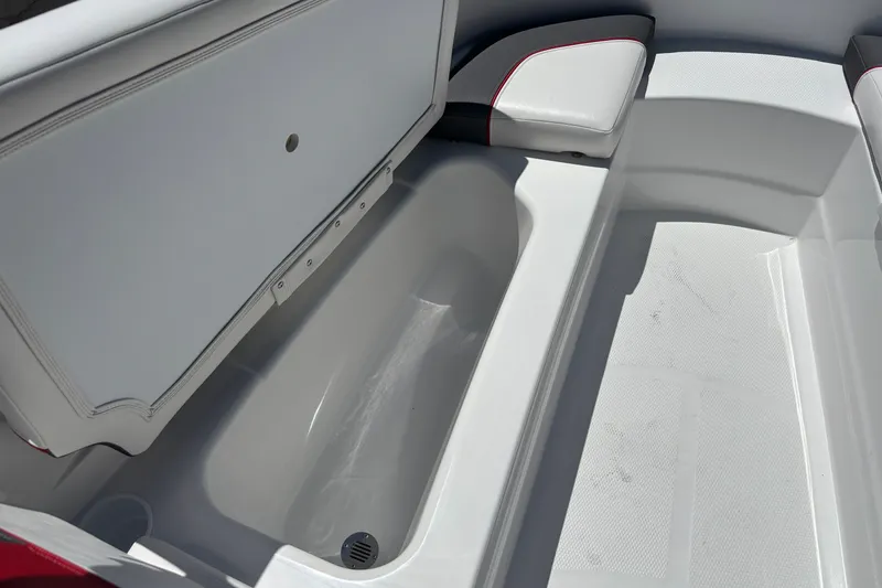 Slide: The Image of 2027 Tahoe T16 boat interior storage compartment with cushioned seating and drain. - 13