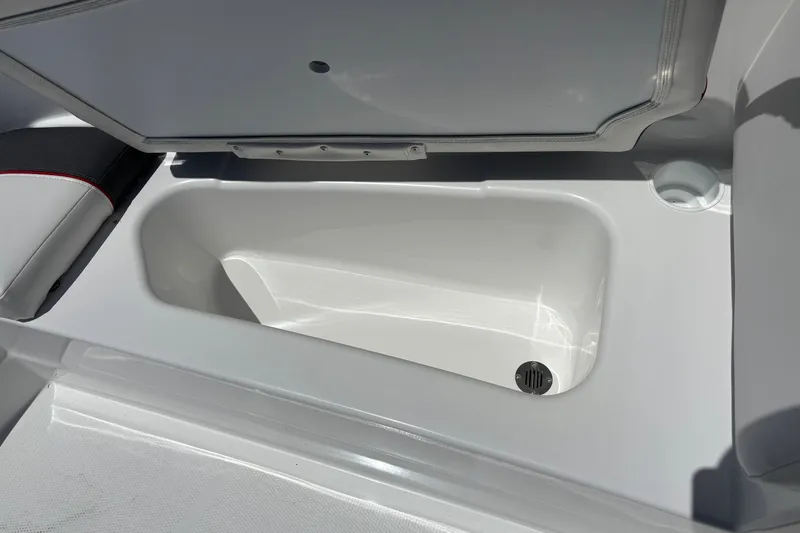 Slide: The Image of 2027 Tahoe T16 boat storage compartment with open lid and drain plug. - 12