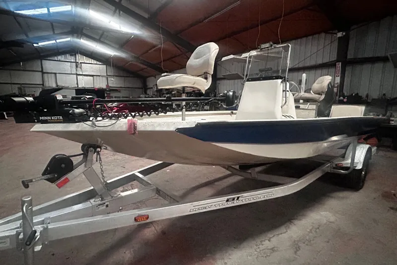 The Image of A 2016 Xpress H18 Bay boat on a trailer inside a warehouse. - 0