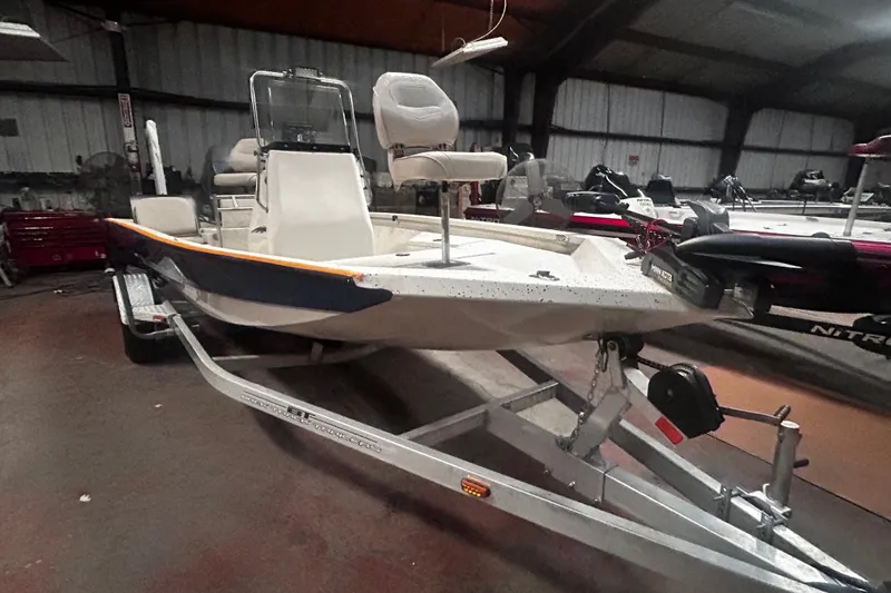 Slide: The Image of 2016 Xpress H18 Bay boat on trailer in indoor storage facility. - 2