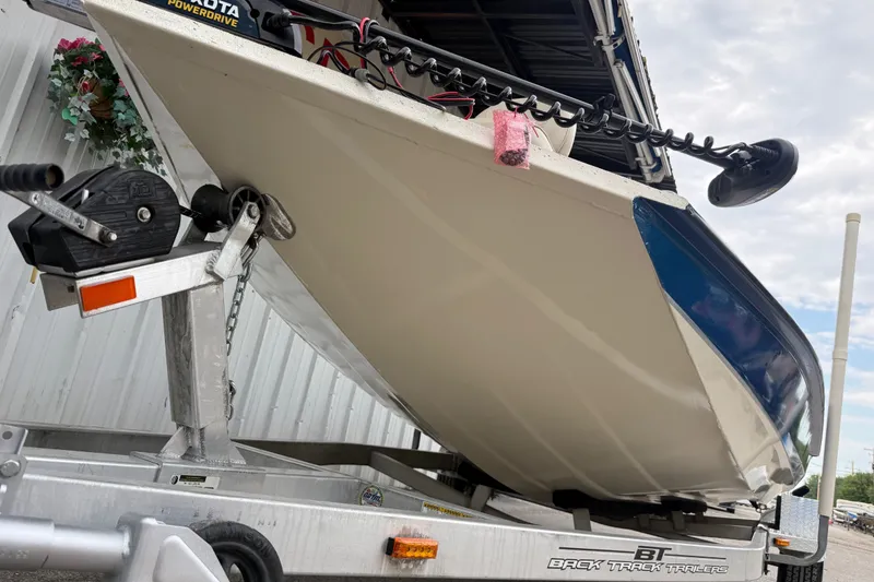 Slide: The Image of 2016 Xpress H18 Bay boat on trailer, featuring Minn Kota PowerDrive trolling motor. - 18