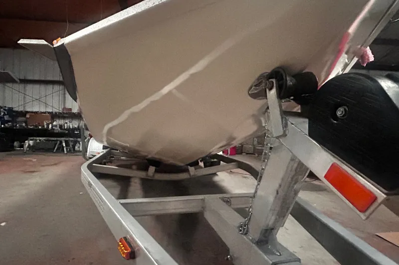 Slide: The Image of 2016 Xpress H18 Bay boat on trailer in a garage setting. - 18