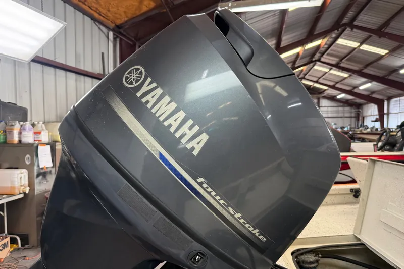 Slide: The Image of Yamaha four-stroke outboard motor on a 2016 Xpress H18 Bay boat in a workshop. - 10