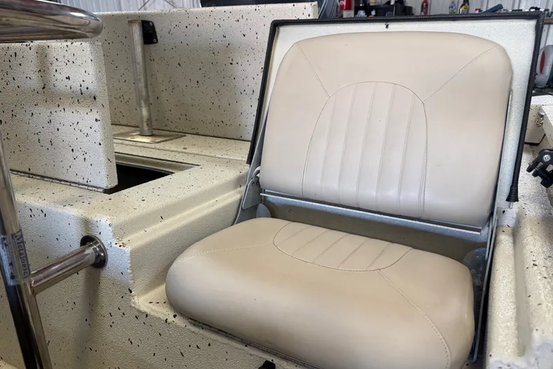Slide: The Image of 2016 Xpress H18 Bay boat with beige seating and speckled interior design. - 7