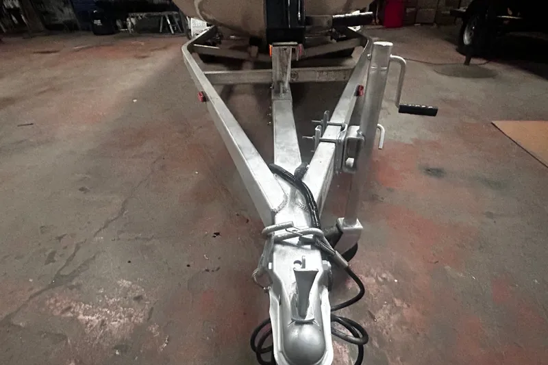 Slide: The Image of 2016 Xpress H18 Bay boat trailer in a garage, showing hitch and winch details. - 20