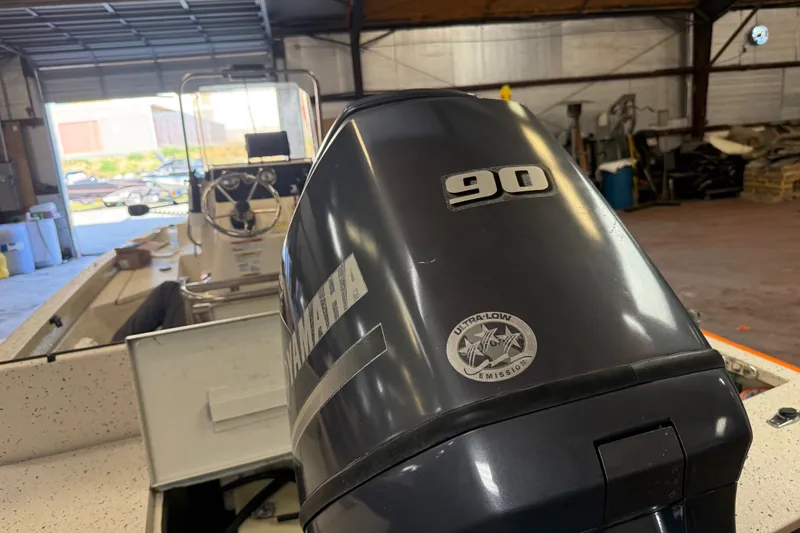 Slide: The Image of 2016 Xpress H18 Bay boat with Yamaha 90 engine in a garage setting. - 11
