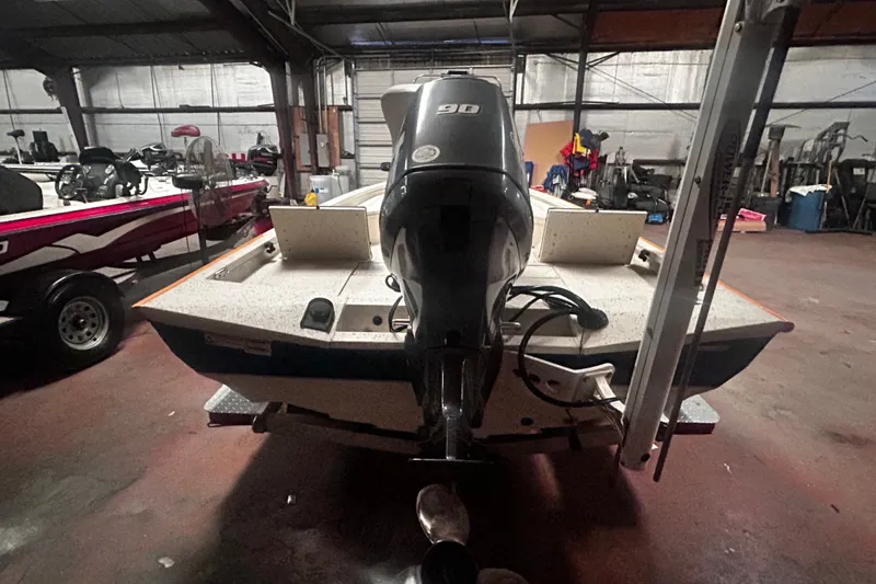 Slide: The Image of 2016 Xpress H18 Bay boat with 90 HP engine in a storage facility. - 4