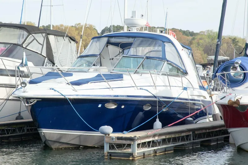 Slide: The Image of A blue 2006 Formula 31 Performance Cruiser docked, surrounded by other boats. - 5
