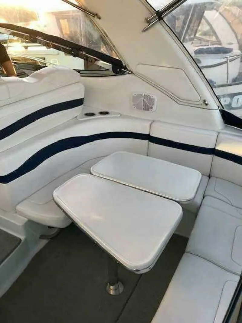Slide: The Image of The interior view shows a white bench seat with blue stripes and a small table. - 8