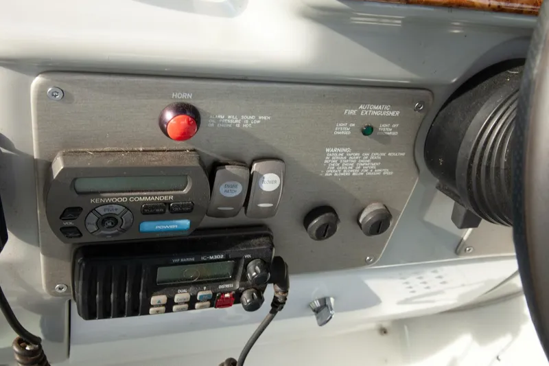 Slide: The Image of Close-up of the helm panel featuring switches and a radio. - 27