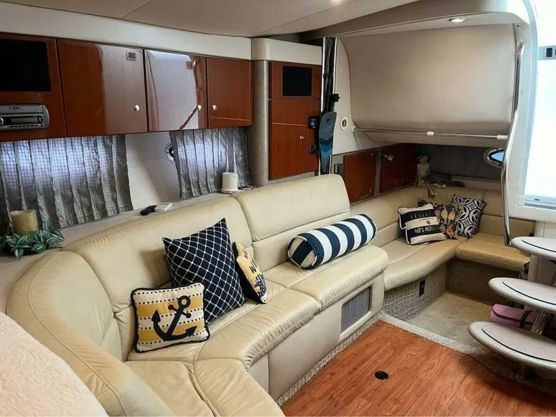 Slide: The Image of The interior of a 2006 Formula 31 Performance Cruiser features a cozy seating area with cushions. - 17