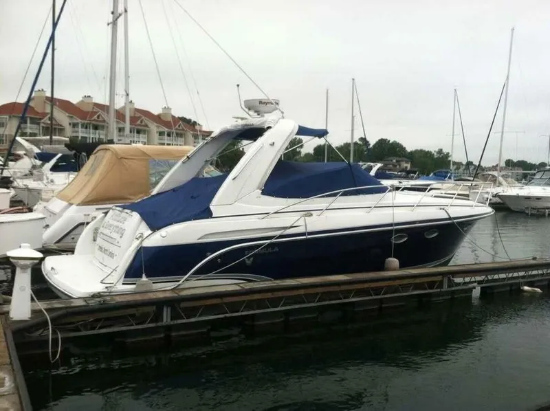 The Image of A blue and white motor yacht docked at a marina, surrounded by other boats. - 0