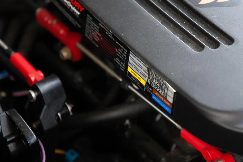 Slide: The Image of Close-up of a boat engine with visible labels and cables. - 32