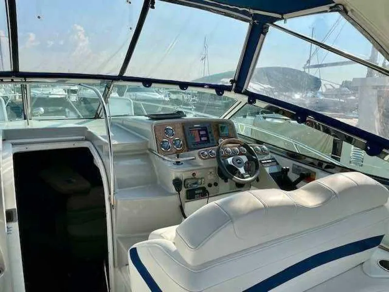 Slide: The Image of The cockpit of a 2006 Formula 31 Performance Cruiser with white and blue seating and modern controls. - 11