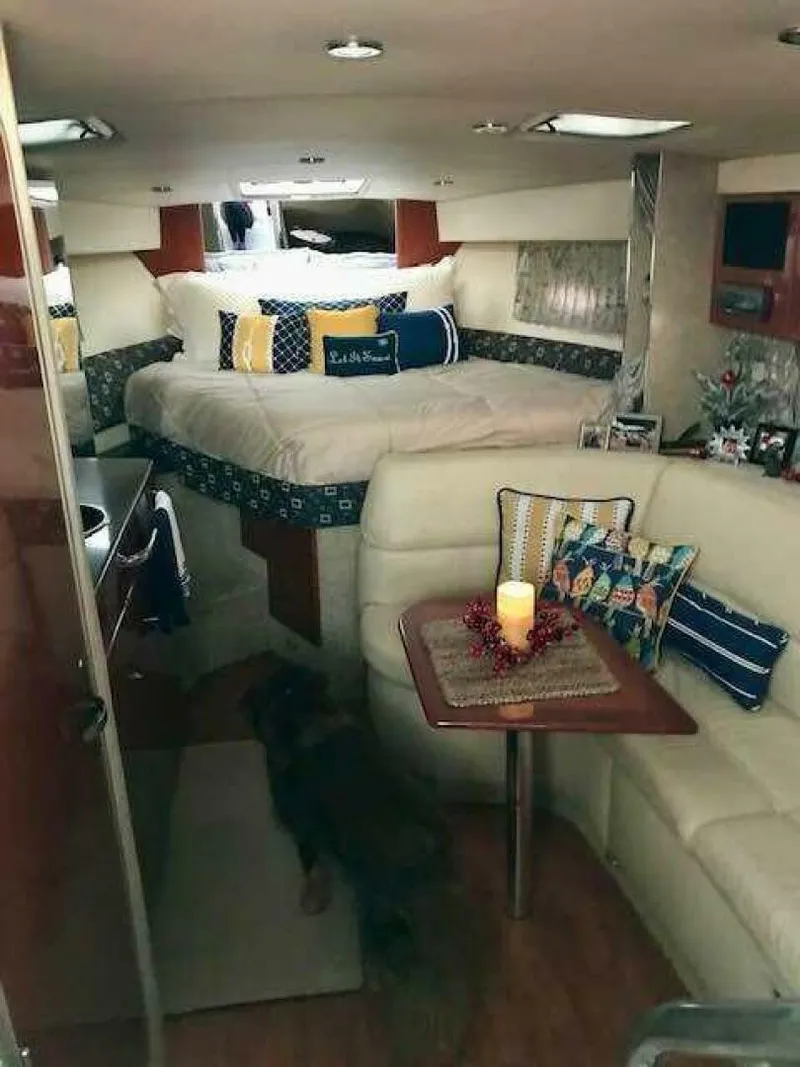 Slide: The Image of The interior of a 2006 Formula 31 Performance Cruiser features a cozy bedroom and dining area. - 14