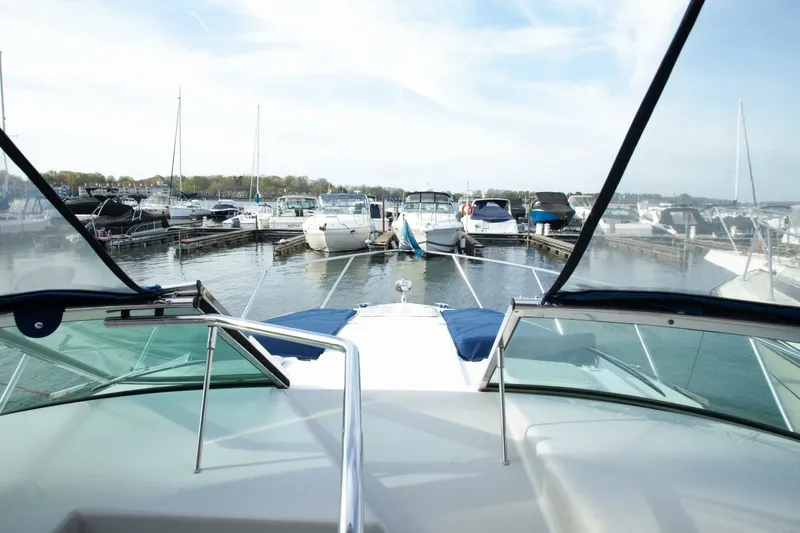 Slide: The Image of View from the cockpit of a 2006 Formula 31 Performance Cruiser overlooking a marina with several boats. - 29
